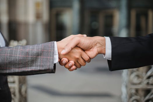 pexels photo 4963437 4963437 1 A close-up of two businesspeople shaking hands, symbolizing cooperation and partnership.